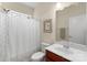 Well-lit bathroom with a decorative shower curtain, white toilet, and a dark vanity at 4001 Perth Rd, Fort Mill, SC 29707