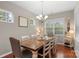 Bright dining room with a large window and a decorative chandelier over a wooden table at 4001 Perth Rd, Fort Mill, SC 29707