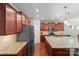 Bright kitchen featuring an oversized granite island, stainless appliances, and hardwood floors at 4001 Perth Rd, Fort Mill, SC 29707