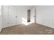Carpeted bedroom with white doors and walls, featuring a view into the hallway at 4083 Hord Rd, Sharon, SC 29742