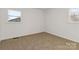 Bright bedroom with neutral walls, light-colored carpet, and two windows offering natural light at 4083 Hord Rd, Sharon, SC 29742