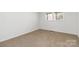 Bedroom with tan carpet and white walls features a window overlooking the yard at 4083 Hord Rd, Sharon, SC 29742