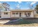 Charming white brick home featuring a covered front porch with rocking chairs at 4083 Hord Rd, Sharon, SC 29742