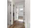 Hallway with doors leading to bedrooms features wood-look flooring and white trim at 4083 Hord Rd, Sharon, SC 29742