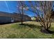 Backyard features a spacious lawn, shade trees, and a patio area adjacent to the home at 4232 Cornelia Ln, Rock Hill, SC 29732