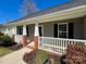 Inviting front porch with brick accents and white railings, perfect for relaxing outdoors at 4232 Cornelia Ln, Rock Hill, SC 29732