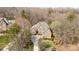 An aerial perspective shows this home’s brick exterior, lush trees and long driveway at 4828 Beth Ln, Harrisburg, NC 28075