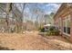 Expansive backyard featuring a deck, patio area, and mature trees, ideal for outdoor activities at 4828 Beth Ln, Harrisburg, NC 28075