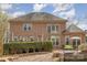 View of brick home from backyard, showcasing the patio, landscaping and overall property size at 4828 Beth Ln, Harrisburg, NC 28075