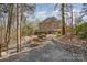 Landscape design with stone paths leads to beautiful backyard with fire pit and mature trees at 4828 Beth Ln, Harrisburg, NC 28075