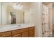 Bathroom with a single vanity, large mirror, and a combined shower and bathtub at 4828 Beth Ln, Harrisburg, NC 28075