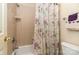 Bathroom featuring shower-tub combination with tile surround and curtain at 4828 Beth Ln, Harrisburg, NC 28075