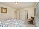Bedroom showcasing a patterned comforter, rocking chair, and access to multiple rooms at 4828 Beth Ln, Harrisburg, NC 28075