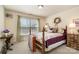 Charming bedroom with a four-poster bed, natural light, and warm, inviting decor at 4828 Beth Ln, Harrisburg, NC 28075