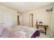 Cozy bedroom featuring neutral walls and a comfortable bed with ensuite bathroom entrances at 4828 Beth Ln, Harrisburg, NC 28075