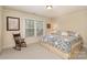 Comfortable bedroom featuring patterned bedding, a rocking chair, and a large window at 4828 Beth Ln, Harrisburg, NC 28075