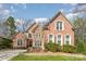 Charming brick home boasts detailed architecture, a lush front lawn, and an American flag at 4828 Beth Ln, Harrisburg, NC 28075