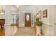 Bright foyer features a soaring ceiling, hardwood floors, an oval front door with sidelights, and elegant decor at 4828 Beth Ln, Harrisburg, NC 28075