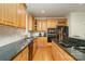 A chef's kitchen with granite counters, stainless appliances, wood cabinets, and a gas cooktop island at 4828 Beth Ln, Harrisburg, NC 28075