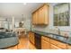 Bright kitchen with granite counters, wood cabinets, double sinks, view to dining area, and modern appliances at 4828 Beth Ln, Harrisburg, NC 28075