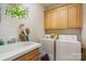 Functional laundry room with sink, washer, dryer, and storage cabinets at 4828 Beth Ln, Harrisburg, NC 28075