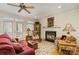 Comfortable living room with a fireplace, hardwood floors, and a view of the outdoor patio at 4828 Beth Ln, Harrisburg, NC 28075