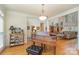 Open-concept living area with hardwood floors, a baby grand piano, and ample natural light at 4828 Beth Ln, Harrisburg, NC 28075