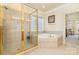 Bright Primary bath featuring a tiled shower and garden tub area with a window at 4828 Beth Ln, Harrisburg, NC 28075