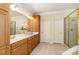 Elegant Primary bathroom featuring double vanities, a glass shower enclosure, and tile flooring at 4828 Beth Ln, Harrisburg, NC 28075