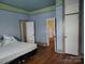 Bedroom with unique color scheme, wood floors, and plentiful storage space at 516 W 7Th St, Kannapolis, NC 28081
