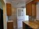 Efficient kitchen features wood cabinets, dishwasher, and exterior door with glass at 516 W 7Th St, Kannapolis, NC 28081