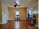 Inviting living room with hardwood floors, ceiling fan, fireplace and large window at 516 W 7Th St, Kannapolis, NC 28081