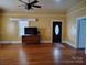 Bright living room features hardwood floors, ceiling fan and front door with oval window at 516 W 7Th St, Kannapolis, NC 28081