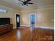 Cozy living room features hardwood floors, ceiling fan, front door and doorway to another room at 516 W 7Th St, Kannapolis, NC 28081