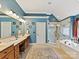 Elegant bathroom with dual vanities, soaking tub, and glass-enclosed shower at 5405 Silver Creek Dr, Waxhaw, NC 28173