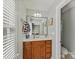 Bathroom with a single sink vanity, framed mirror, and natural light at 5405 Silver Creek Dr, Waxhaw, NC 28173