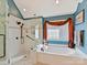 Modern bathroom featuring a soaking tub and a luxurious glass-enclosed shower at 5405 Silver Creek Dr, Waxhaw, NC 28173