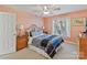 Cozy bedroom featuring a comfortable bed with patterned bedding, side tables, and a bright window view at 5405 Silver Creek Dr, Waxhaw, NC 28173