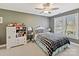 Comfortable bedroom with a large window, ceiling fan, and cozy decor at 5405 Silver Creek Dr, Waxhaw, NC 28173