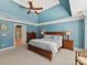 Inviting bedroom with ensuite bathroom access, tray ceilings, and natural light at 5405 Silver Creek Dr, Waxhaw, NC 28173