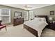 Serene bedroom with a dark wood dresser, bed with white linens, and natural light from two windows at 5405 Silver Creek Dr, Waxhaw, NC 28173