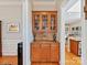 Butler's pantry featuring granite countertops, glass display cabinets, and hardwood floors at 5405 Silver Creek Dr, Waxhaw, NC 28173