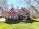 Charming brick two-story home with a covered front porch and well-manicured lawn at 5405 Silver Creek Dr, Waxhaw, NC 28173