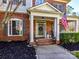 Inviting front porch adorned with decorative wreath and American flag at 5405 Silver Creek Dr, Waxhaw, NC 28173