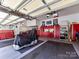 Spacious garage with organized storage, tool chests, and a motorcycle under a cover at 5405 Silver Creek Dr, Waxhaw, NC 28173