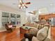 Spacious living room featuring hardwood floors, fireplace, and large windows at 5405 Silver Creek Dr, Waxhaw, NC 28173