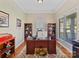 Inviting home office featuring a hardwood floor, natural light, custom shelves and classic trim at 5405 Silver Creek Dr, Waxhaw, NC 28173