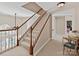 Carpeted staircase with wood railing and white balusters leads to upper level at 5405 Silver Creek Dr, Waxhaw, NC 28173