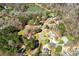 An aerial view highlights this property nestled among mature trees in a charming neighborhood with a tranquil lake at 7306 Timbercreek Ct, Denver, NC 28037