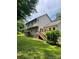 Backyard with a large deck, green lawn and mature trees at 7306 Timbercreek Ct, Denver, NC 28037